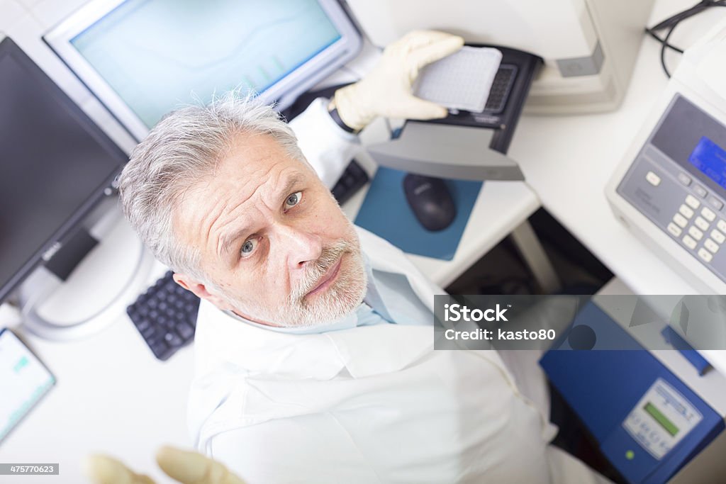 Life science researcher . Life science researcher  performing a genotyping testing which enables personalized medicine. PM is a medical model that proposes the customization of healthcare. Scientist Stock Photo
