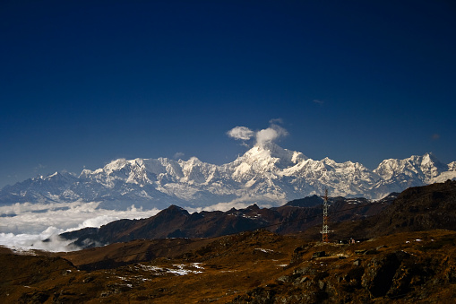 This picture is taken in state of Sikkim, India. From northern part of state on a clear day near Nathu-la pass you can witness complete Kangchenjunga mountain range above clouds.