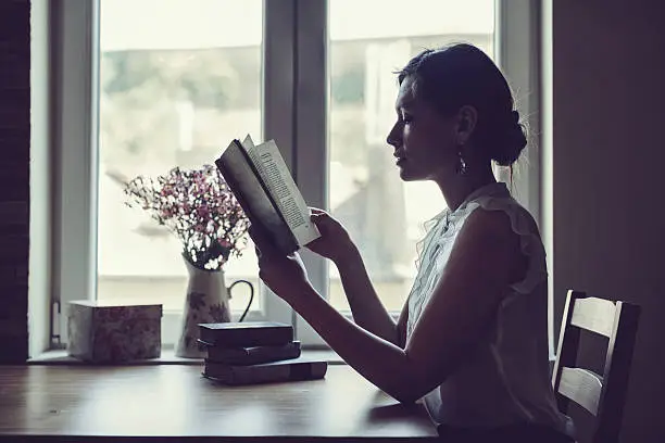 Photo of Beautiful woman reading a book