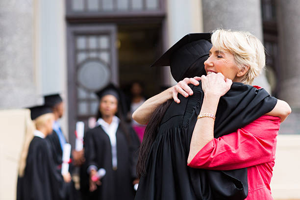 istock young female graduate hugging mother 475773457