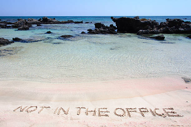 istock OUT OF OFFICE written in sand on a beautiful beach 475773973