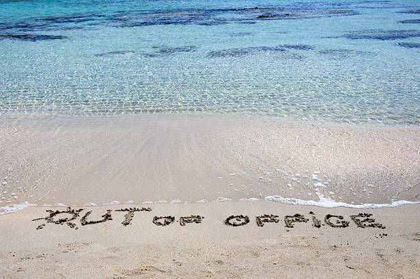 istock OUT OF OFFICE written in sand on a beautiful beach 475773993