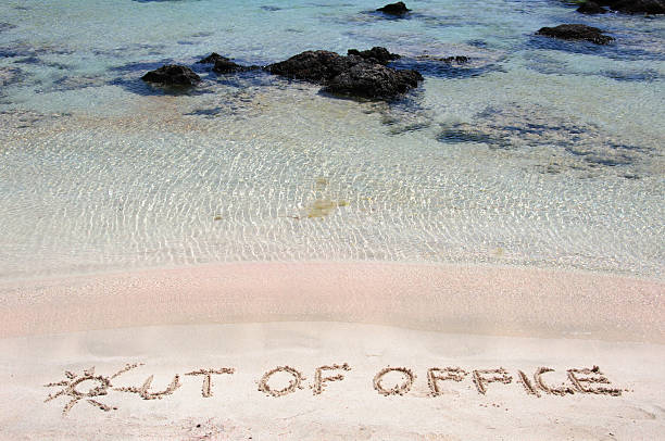 istock OUT OF OFFICE written in sand on a beautiful beach 475774039