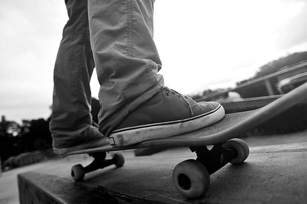istock skateboarding legs at skatepark 475774496