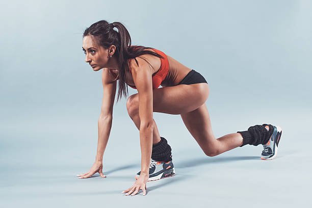 istock Sportive athlete woman sprinter waiting for the start running position 475776038