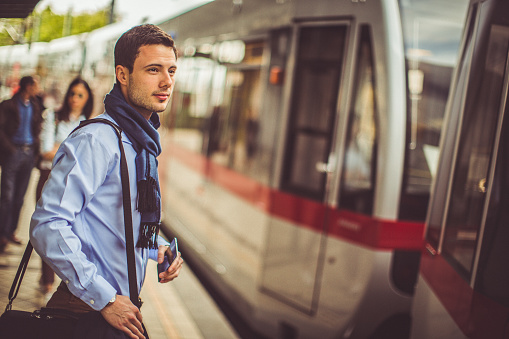Photo of young man waiting for the train