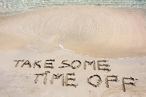 istock TAKE SOME TIME OFF written in sand on a beach 475778865