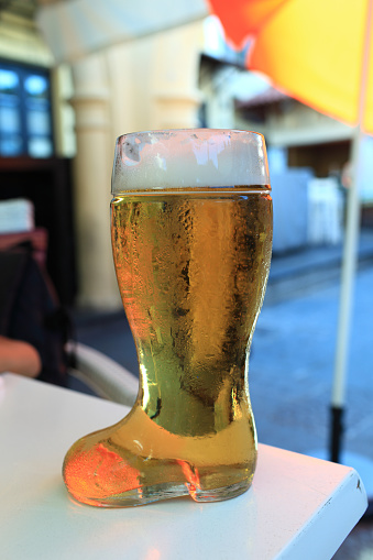 Beer in boot glass on the table