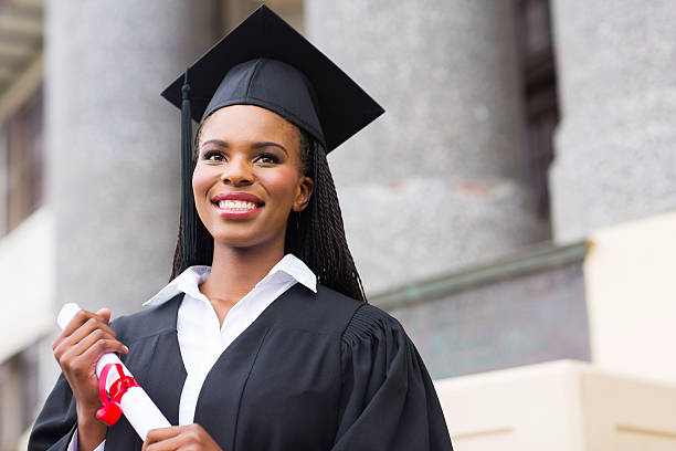 pretty african american female graduate pretty african american female graduate outside college building diploma photos stock pictures, royalty-free photos & images