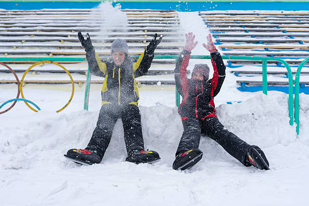 istock Boys in skates throwing snow above their heads 475786825