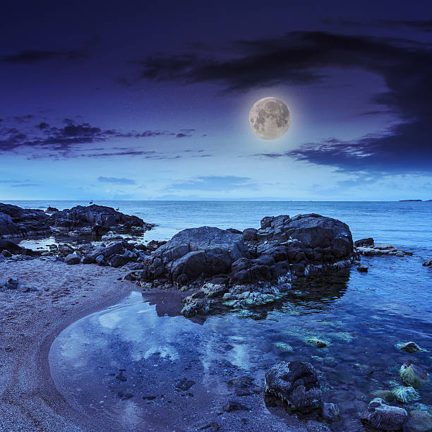 istock sea shore landscape with boulders at night 475790143