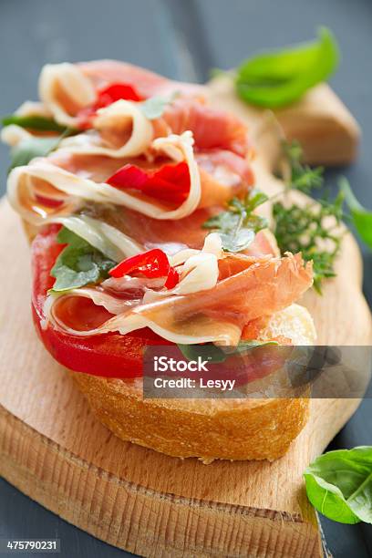 Bruschetta With Prosciutto Tomato And Basil Stock Photo - Download Image Now - Antipasto, Appetizer, Basil