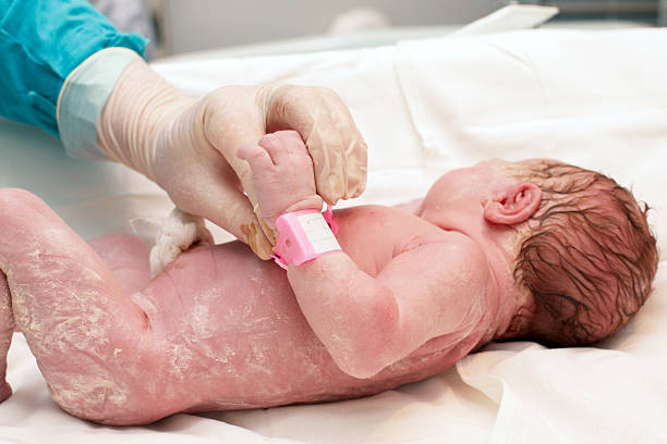 istock doctor examines a newborn baby 475793979