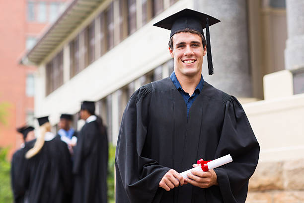 young male university graduate - toga stockfoto's en -beelden