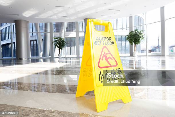 Hallway With A Caution Sign In English Stock Photo - Download Image Now - Advice, Built Structure, Care