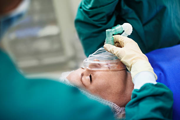 Her surgery is in skilled hands Shot of a surgeon using a mask on a patient during an operationhttp://195.154.178.81/DATA/i_collage/pu/shoots/804719.jpg oxygen tank stock pictures, royalty-free photos & images