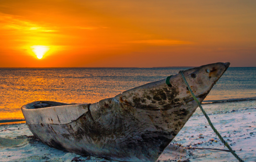 Scenic view of sunset in Zanzibar with typical Zanzibarian wooden canoe in Kendwa beach 