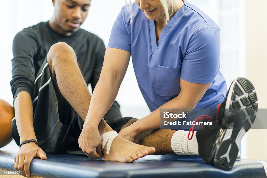 Physical Therapy An athlete receiving rehibilitative care for a sports injury. Physical Injury Stock Photo