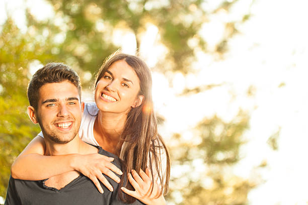 istock Young man giving woman piggyback ride 475806799