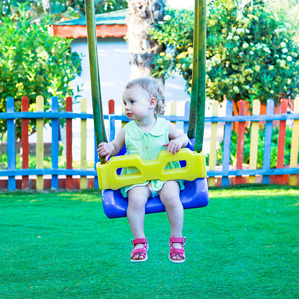 istock Little girl on the swing 475808870