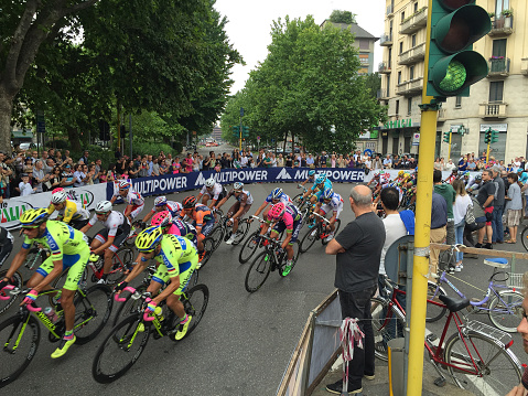 Milan, Italy - May 31, 2015: Tour of Italy 2015 race, cyclists entering to Milan on their final stage of the race to the welcoming crowd and fans cheering on the side of the streets roads of Milan city centre. Giro d'italia 2015. 