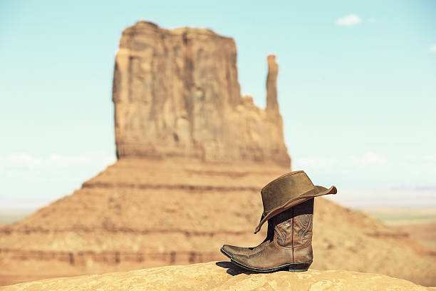 istock Boots and hat in front of Monument Valley 475811315
