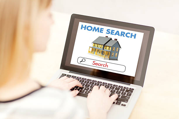 istock Woman Using Laptop Computer to Search for New Home 475811667