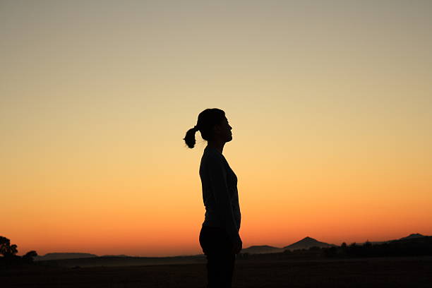 istock Woman at Sunset 475812519