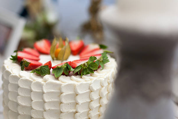 cake with cream and strawberries on a light wooden background
