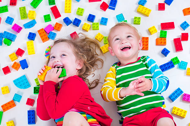 istock Kids playing with colorful blocks 475819428