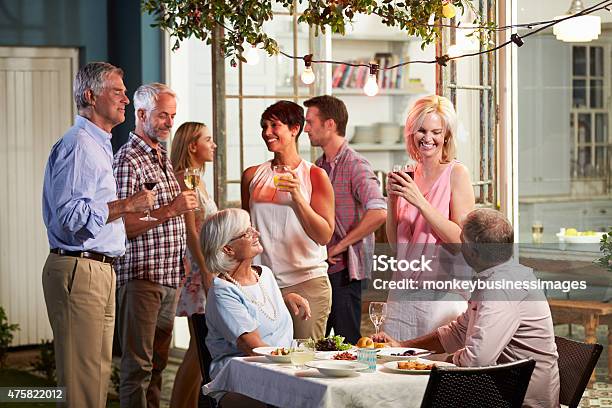 Group Of Friends Enjoying Outdoor Evening Drinks Party Stock Photo - Download Image Now