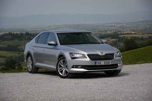 Siena, Italy, 14th May, 2015: Skoda Superb stopped on the road during the test drive. The first generation of Superb was debut in 2001 on the market. The third generation of luxury liftback from Skoda is powered by diesel or petrol engines (pushing out 110-280 HP). The Superb is the most luxury car in Skoda offer.