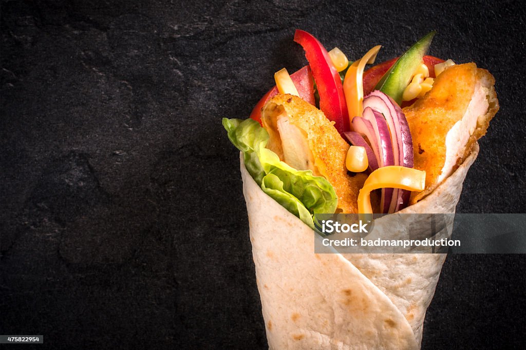 Chicken wrap Popular chicken wrap sandwich on black background with blank space Wrap Sandwich Stock Photo