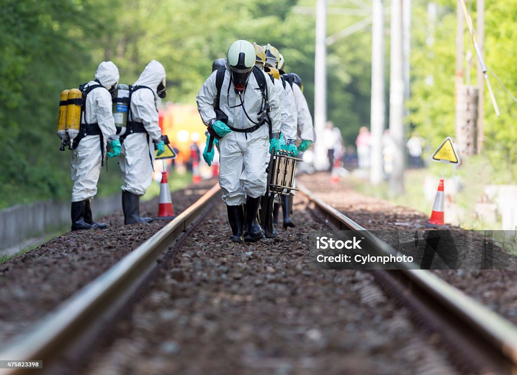 Toxic chemicals and acids emergency team A team working with toxic acids and chemicals is approaching a chemical cargo train crash near Sofia, Bulgaria. Teams from Fire department are participating in an emergency training with spilled toxic and flammable materials. Biochemical Weapon Stock Photo