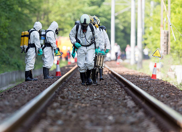 Toxic chemicals and acids emergency team A team working with toxic acids and chemicals is approaching a chemical cargo train crash near Sofia, Bulgaria. Teams from Fire department are participating in an emergency training with spilled toxic and flammable materials. biochemical weapon photos stock pictures, royalty-free photos & images