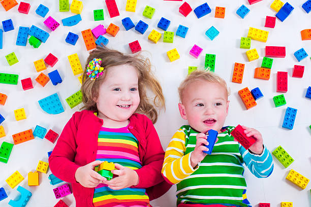 istock Beautiful kids playing with colorful blocks 475827354