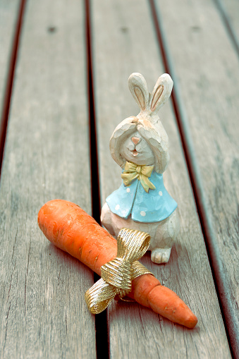 Vintage tone Wooden rabbit with fresh carrot