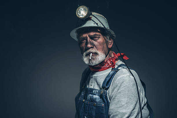 istock Male Mining Worker with Smoke Looking at Camera 475833626