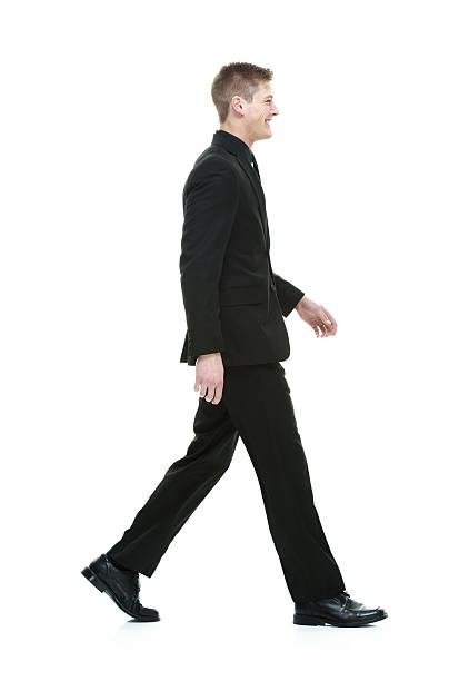 istock Smiling businessman walking and looking away 475834624