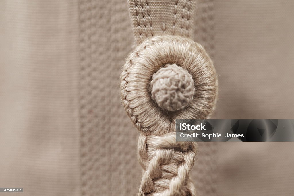 Abstract detail of a Tarboosh which is Arabic style tie An abstract detail of a Tarboosh which is an Arabic style (tassel like) tie that is usually worn with a thawb or kandura in Arabia. Adult Stock Photo