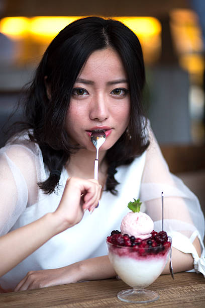 istock Woman eating ice cream 475835536