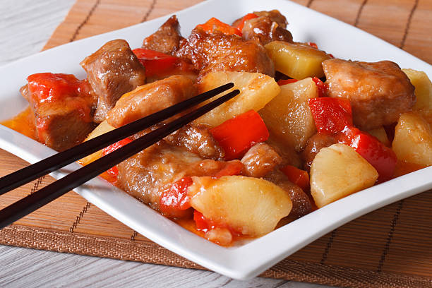 istock pork meat with pineapple and vegetables and sauce 475836290