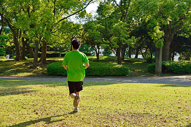 running jogging training park nature recreating listen music healthy life