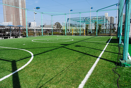 Futsal court in a public outdoor park with artificial turf