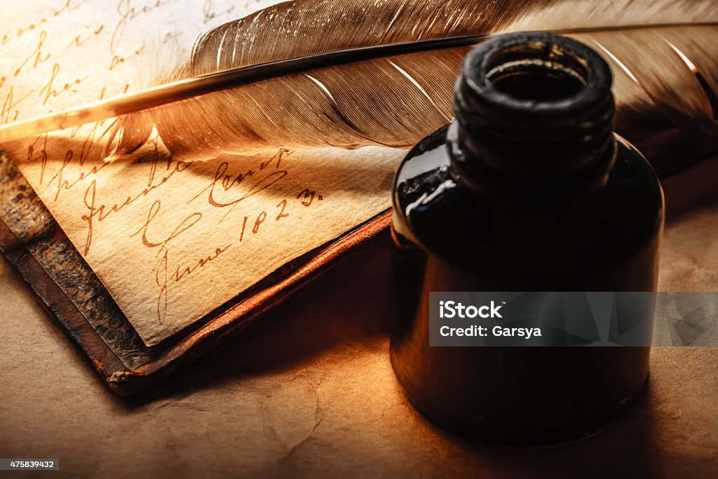 Old book with feather pen Old book with feather pen and inkpot Old-fashioned Stock Photo
