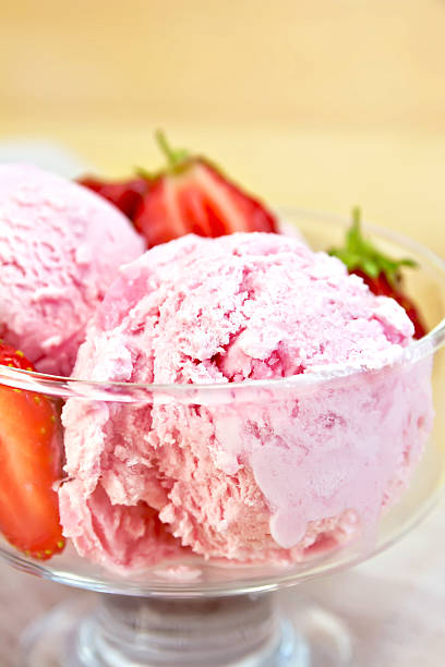 istock Ice cream strawberry in glass bowl on board 475840188