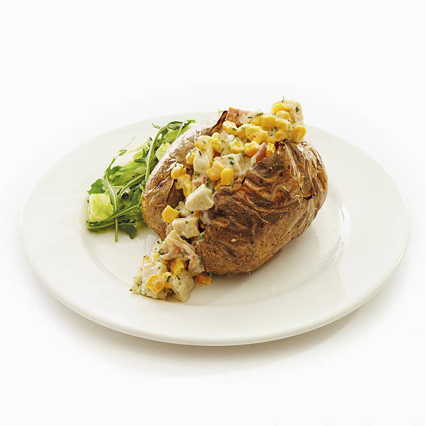 istock Baked jacket potato on plate with salad 475840614