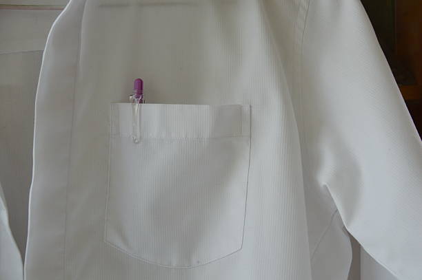istock pen in white shirt pocket hanging on the wall 475841188