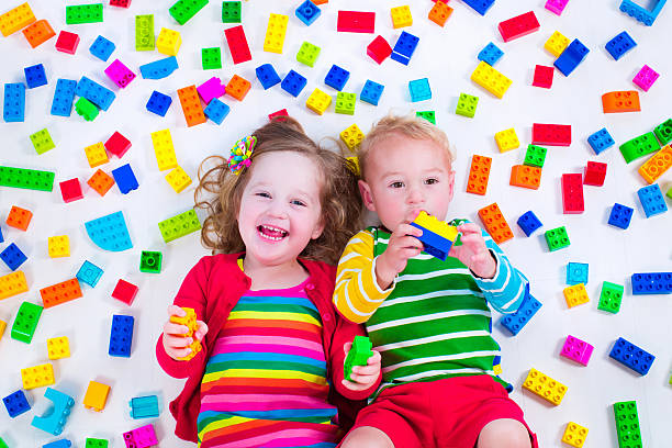 istock Cute kids playing with colorful blocks 475842312