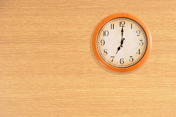 istock Clock showing 7 o'clock on a wooden wall 475842442